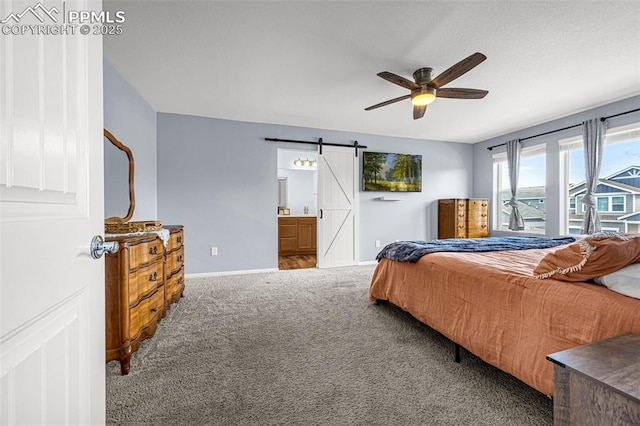 10597 Luneth Dr, Colorado Springs, CO 80925 - bedroom featuring carpet flooring, a barn door, baseboards, ensuite bath, and a ceiling fan
