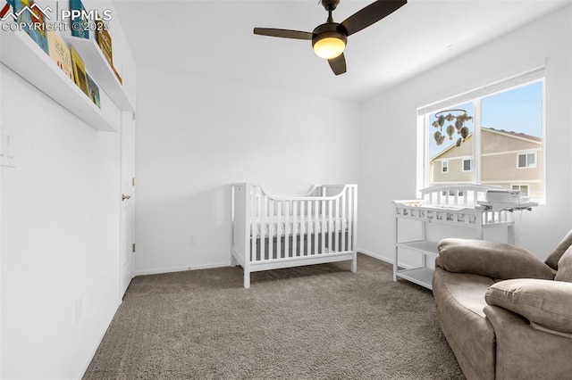 10597 Luneth Dr, Colorado Springs, CO 80925 - carpeted bedroom featuring a crib, a ceiling fan, and baseboards