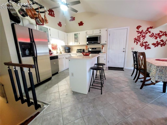2115 Rangeview Dr, Pueblo, CO 81008 - kitchen featuring stainless steel appliances, light countertops, a kitchen island, white cabinets, and a ceiling fan