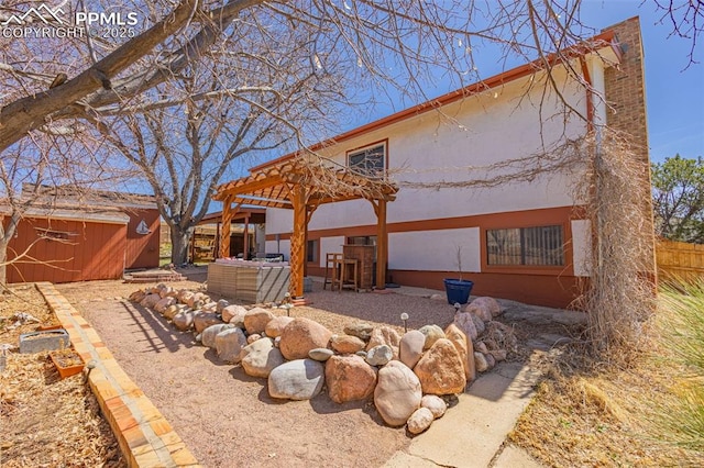 2115 Rangeview Dr, Pueblo, CO 81008 - rear view of house with stucco siding and a patio