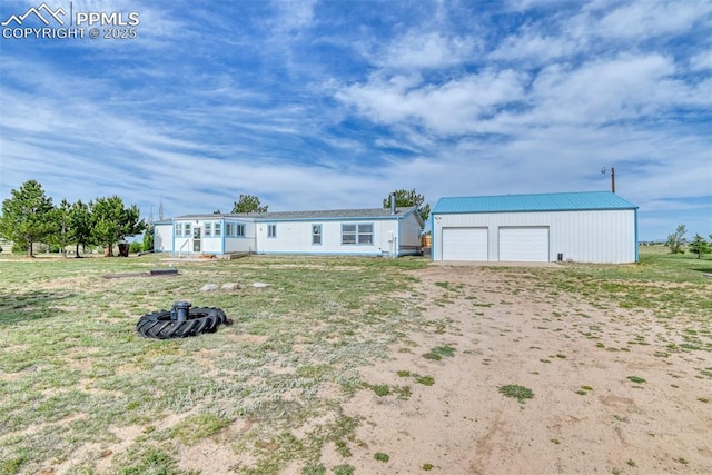 20040 Drennan Rd, Colorado Springs, CO 80928 - view of front of house with a detached garage and an outbuilding