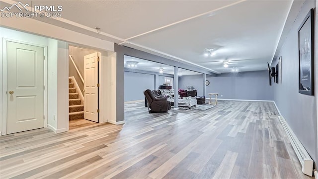 971 S Los Charros Dr, Pueblo West, CO 81007 - finished basement featuring a ceiling fan, stairway, light wood-style flooring, and baseboards