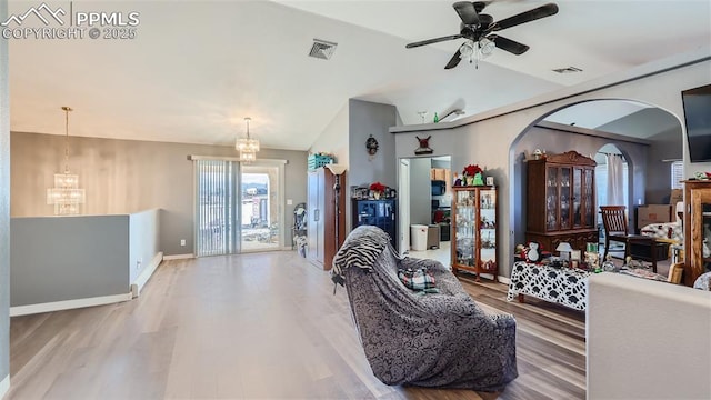 971 S Los Charros Dr, Pueblo West, CO 81007 - living room featuring a chandelier, lofted ceiling, wood finished floors, ceiling fan, and arched walkways