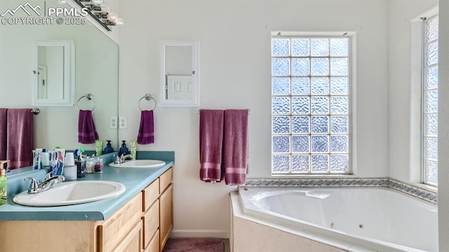 971 S Los Charros Dr, Pueblo West, CO 81007 - full bathroom featuring healthy amount of natural light, double vanity, a whirlpool tub, and baseboards