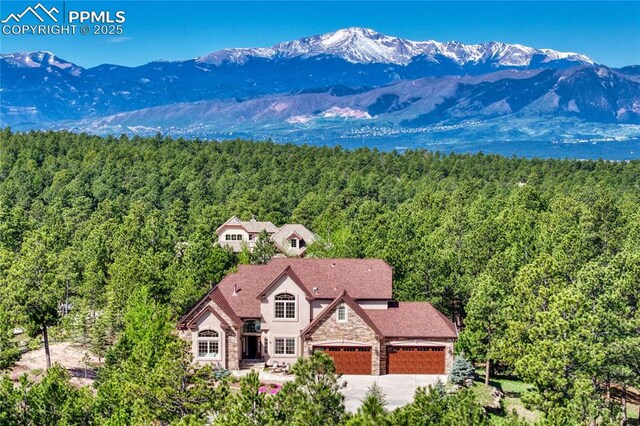 14745 Millhaven Pl, Colorado Springs, CO 80908 - view of subject property featuring a forest and a mountain backdrop