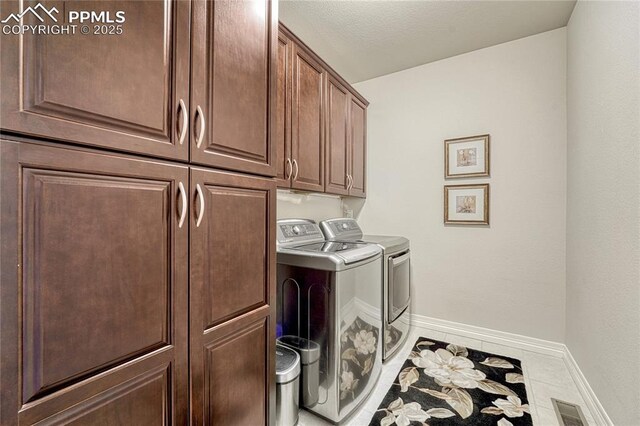 14745 Millhaven Pl, Colorado Springs, CO 80908 - laundry room with separate washer and dryer, cabinet space, baseboards, and tile patterned flooring