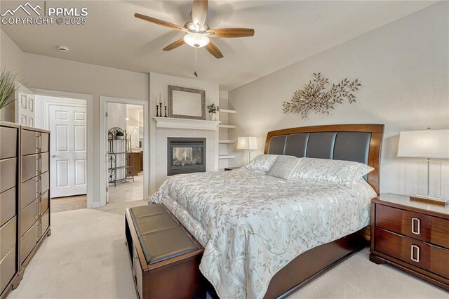 14745 Millhaven Pl, Colorado Springs, CO 80908 - bedroom featuring light colored carpet, a fireplace, and a ceiling fan