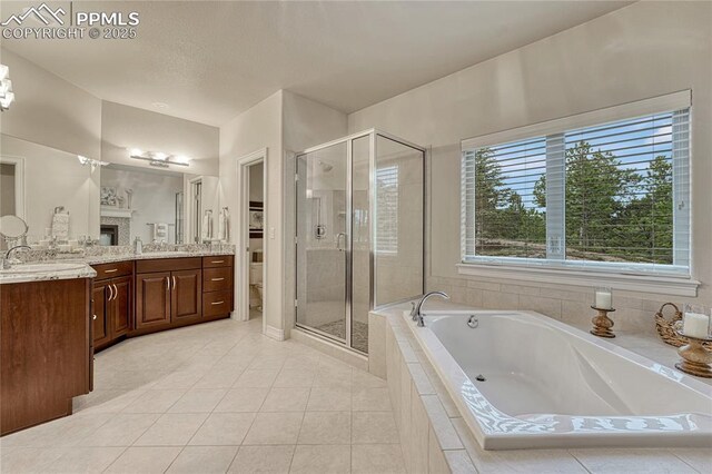 14745 Millhaven Pl, Colorado Springs, CO 80908 - bathroom featuring a stall shower, vanity, a bath, and tile patterned floors