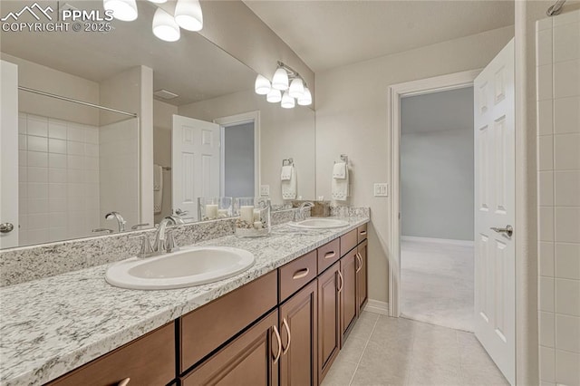 14745 Millhaven Pl, Colorado Springs, CO 80908 - full bathroom with double vanity, tile patterned flooring, baseboards, and a shower