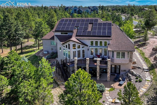 14745 Millhaven Pl, Colorado Springs, CO 80908 - back of property with stucco siding, a patio, and roof with shingles