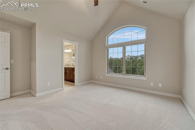 14745 Millhaven Pl, Colorado Springs, CO 80908 - unfurnished bedroom featuring light colored carpet, lofted ceiling, baseboards, and ensuite bathroom
