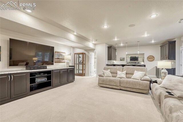 14745 Millhaven Pl, Colorado Springs, CO 80908 - living room featuring light colored carpet, baseboards, and recessed lighting