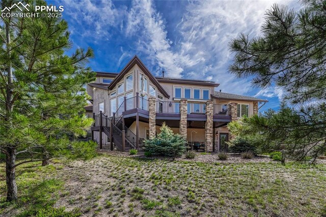 14745 Millhaven Pl, Colorado Springs, CO 80908 - back of house featuring stucco siding, stone siding, stairway, and a deck