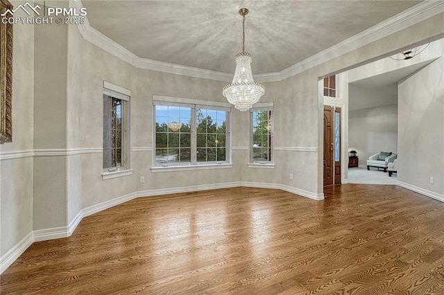 14745 Millhaven Pl, Colorado Springs, CO 80908 - unfurnished dining area with wood finished floors, a chandelier, baseboards, and ornamental molding