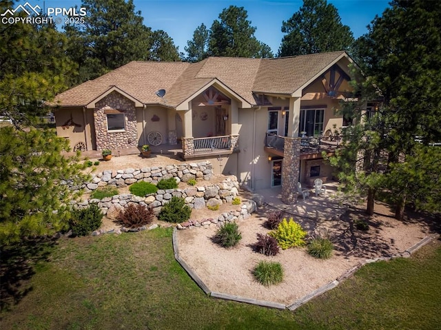 8610 Wildridge Rd, Colorado Springs, CO 80908 - view of front facade with stucco siding, stone siding, and a front yard