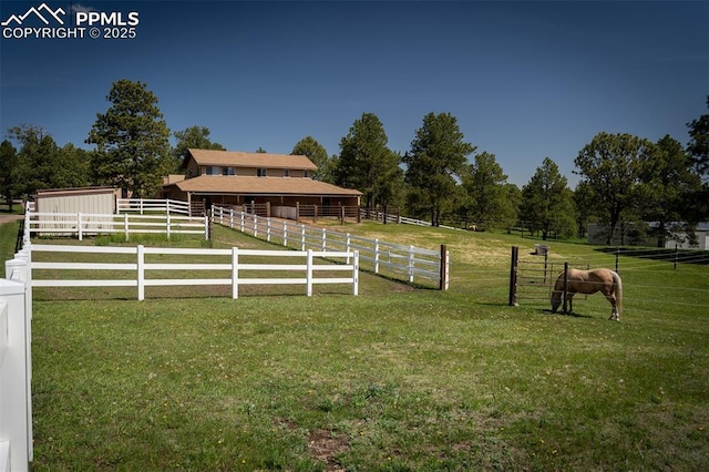 8610 Wildridge Rd, Colorado Springs, CO 80908 - view of grassy yard with an outdoor structure, an exterior structure, and a view of rural / pastoral area