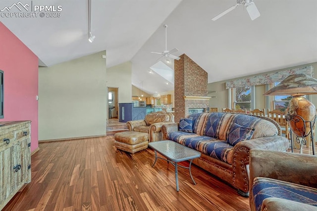 17580 Chipped Arrow Way, Monument, CO 80132 - living room featuring ceiling fan, hardwood / wood-style flooring, baseboards, rail lighting, and high vaulted ceiling