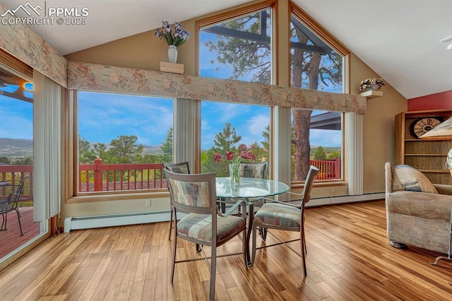 17580 Chipped Arrow Way, Monument, CO 80132 - dining space featuring a baseboard heating unit, wood finished floors, high vaulted ceiling, and healthy amount of natural light