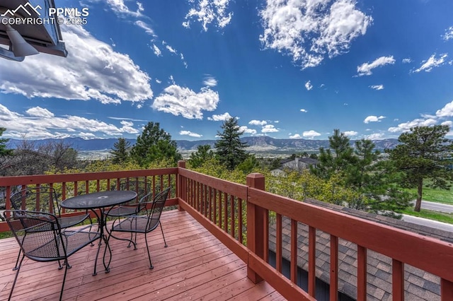 17580 Chipped Arrow Way, Monument, CO 80132 - wooden deck featuring outdoor dining area and a mountain view