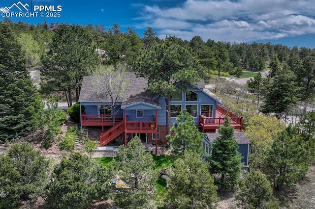 17580 Chipped Arrow Way, Monument, CO 80132 - back of house with stairs, a deck, and a wooded view