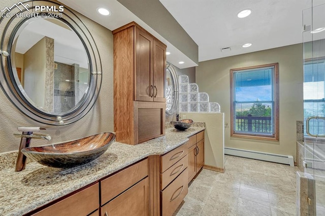 17580 Chipped Arrow Way, Monument, CO 80132 - bathroom featuring baseboard heating, vanity, baseboards, recessed lighting, and a shower with shower door