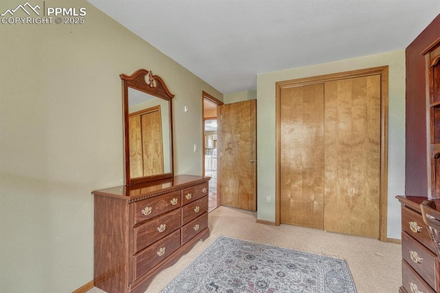 17580 Chipped Arrow Way, Monument, CO 80132 - bedroom featuring light carpet, a closet, and baseboards