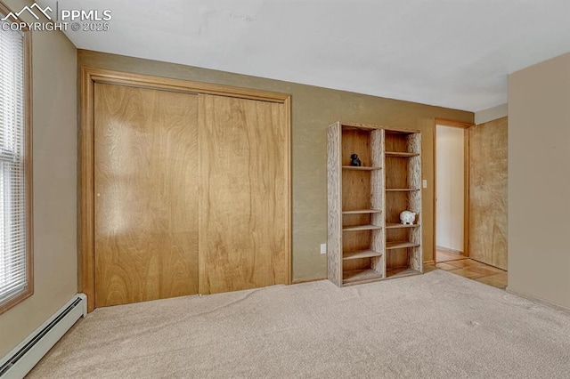 17580 Chipped Arrow Way, Monument, CO 80132 - unfurnished bedroom with a baseboard radiator, a closet, and carpet flooring