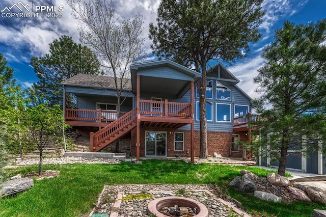 17580 Chipped Arrow Way, Monument, CO 80132 - rear view of property featuring a fire pit, a deck, a lawn, stairway, and brick siding