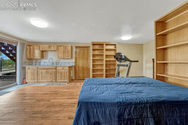17580 Chipped Arrow Way, Monument, CO 80132 - bedroom featuring access to outside, light wood-style flooring, and a sink