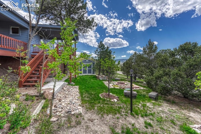 17580 Chipped Arrow Way, Monument, CO 80132 - view of yard featuring stairs, a deck, and an outdoor fire pit