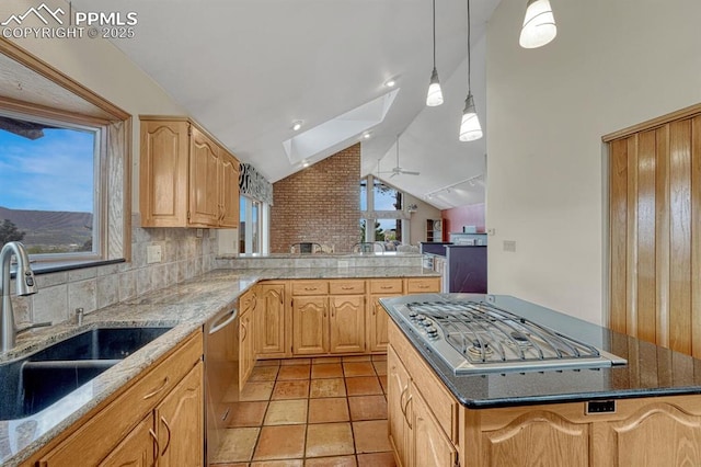 17580 Chipped Arrow Way, Monument, CO 80132 - kitchen featuring a sink, stainless steel appliances, vaulted ceiling, decorative backsplash, and a peninsula