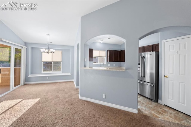 3730 Penny Pt Unit G, Colorado Springs, CO 80906 - kitchen featuring stainless steel fridge, light countertops, lofted ceiling, plenty of natural light, and dark brown cabinets