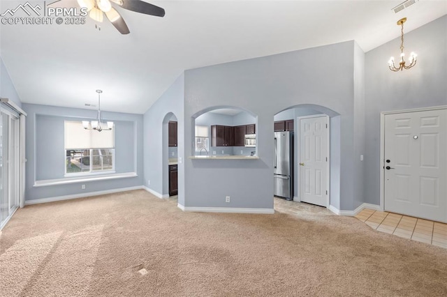 3730 Penny Pt Unit G, Colorado Springs, CO 80906 - unfurnished living room featuring a chandelier, light colored carpet, lofted ceiling, ceiling fan, and baseboards