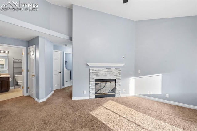 3730 Penny Pt Unit G, Colorado Springs, CO 80906 - unfurnished living room featuring carpet, baseboards, a glass covered fireplace, and a ceiling fan