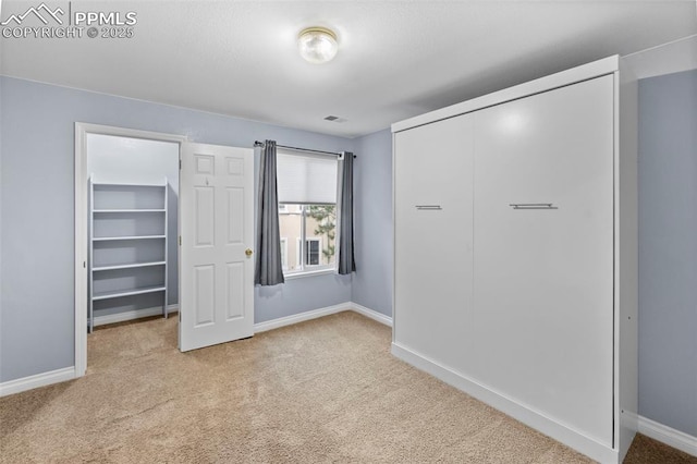 3730 Penny Pt Unit G, Colorado Springs, CO 80906 - unfurnished bedroom featuring carpet flooring, a closet, and baseboards