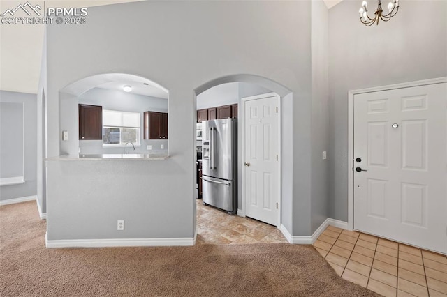 3730 Penny Pt Unit G, Colorado Springs, CO 80906 - kitchen featuring high end refrigerator, light colored carpet, a high ceiling, light countertops, and dark brown cabinets