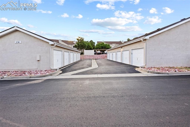 3730 Penny Pt Unit G, Colorado Springs, CO 80906 - view of asphalt road featuring community garages and curbs