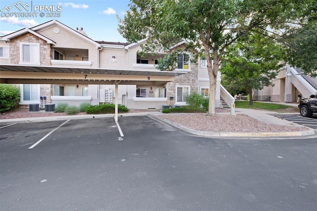 3730 Penny Pt Unit G, Colorado Springs, CO 80906 - view of front of property with stone siding, stucco siding, covered parking, and stairway
