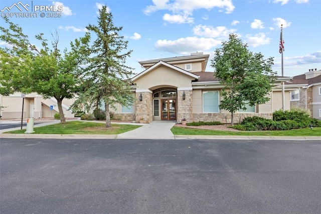 3730 Penny Pt Unit G, Colorado Springs, CO 80906 - view of front facade with french doors, stone siding, and stucco siding