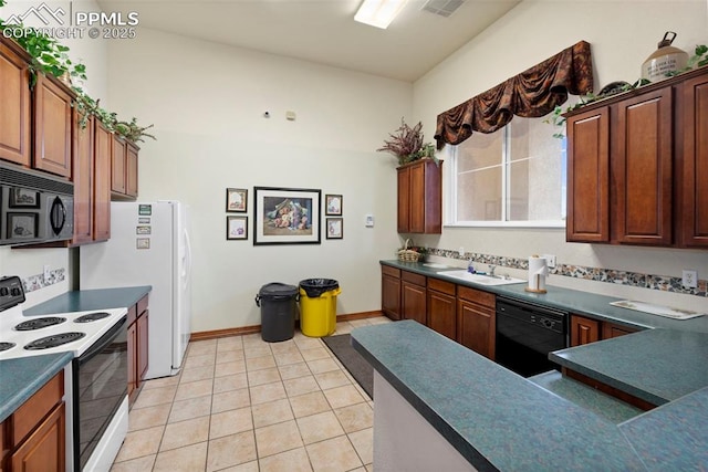 3730 Penny Pt Unit G, Colorado Springs, CO 80906 - kitchen featuring black appliances, dark countertops, light tile patterned floors, and a sink
