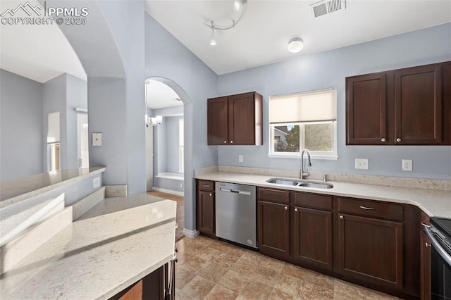 3730 Penny Pt Unit G, Colorado Springs, CO 80906 - kitchen with appliances with stainless steel finishes, a sink, vaulted ceiling, arched walkways, and dark brown cabinetry