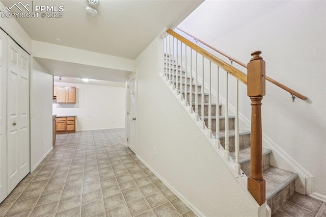 7619 Steward Ln, Colorado Springs, CO 80922 - stairway featuring baseboards
