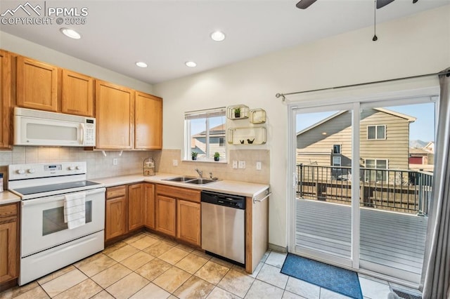 7619 Steward Ln, Colorado Springs, CO 80922 - kitchen featuring white appliances, a sink, light countertops, tasteful backsplash, and recessed lighting