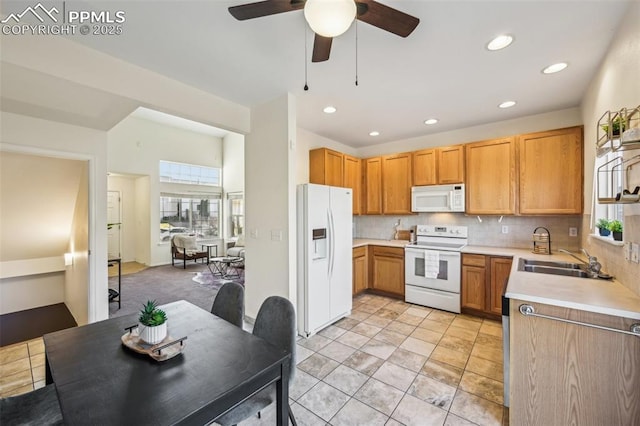 7619 Steward Ln, Colorado Springs, CO 80922 - kitchen with white appliances, a sink, healthy amount of natural light, light countertops, and recessed lighting