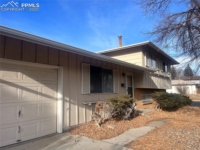 1402 Yosemite Dr, Colorado Springs, CO 80910 - view of front of house with board and batten siding and a garage