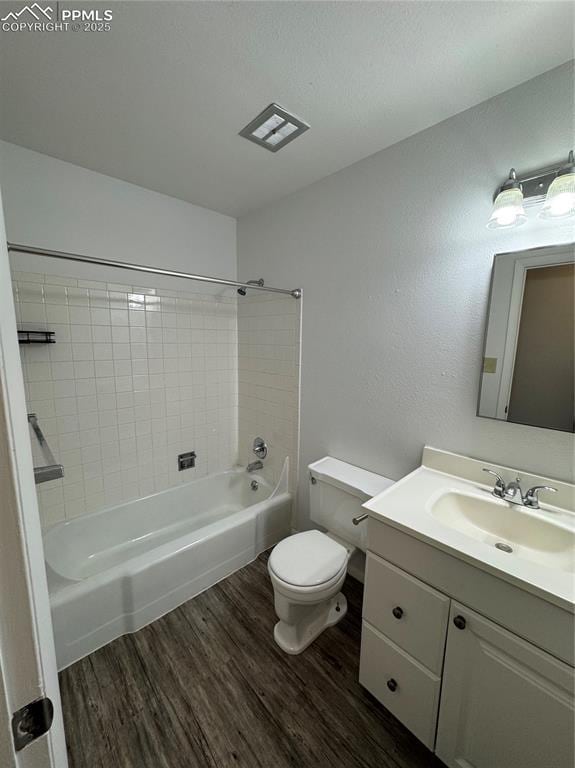 1402 Yosemite Dr, Colorado Springs, CO 80910 - bathroom featuring wood finished floors, toilet, vanity, and tub / shower combination