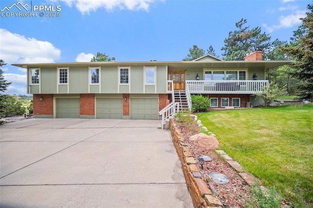 435 W Woodmen Rd, Colorado Springs, CO 80919 - view of front of house featuring brick siding, a garage, concrete driveway, a front yard, and stairway