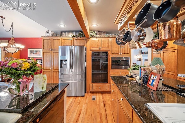 435 W Woodmen Rd, Colorado Springs, CO 80919 - kitchen featuring stainless steel appliances, a chandelier, light wood-style flooring, brown cabinetry, and hanging light fixtures