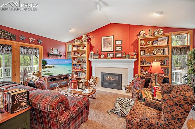 435 W Woodmen Rd, Colorado Springs, CO 80919 - living area with lofted ceiling, carpet, and a fireplace with flush hearth