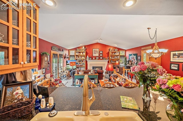 435 W Woodmen Rd, Colorado Springs, CO 80919 - living area featuring vaulted ceiling and a warm lit fireplace